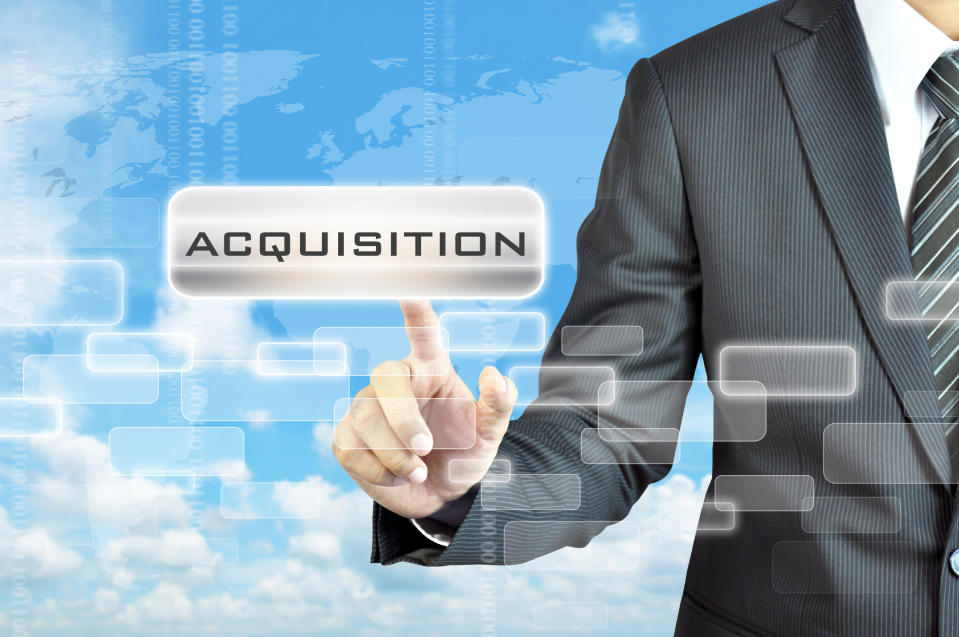 Businessman pointing to the word acquisition