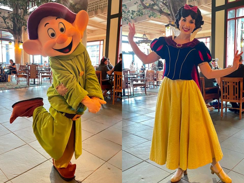 dopey and snow white posing for photos at story book dining in disney world