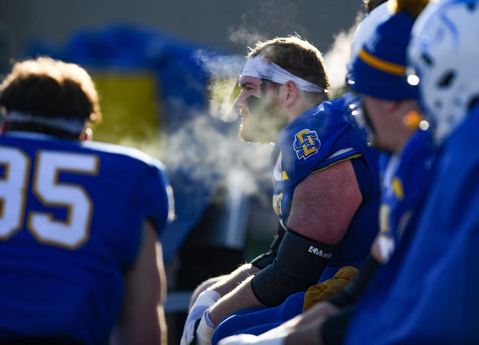 South Dakota State football players’ breath is visible in the cold air during an FCS playoff game against Delaware on December 3, 2022, at Dana J. Dykhouse Stadium in Brookings.