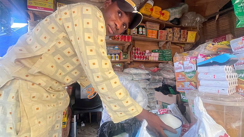 Abba Usman sells granulated sugar at his shop inside a market in Abuja, Nigeria, 27 October 2023.