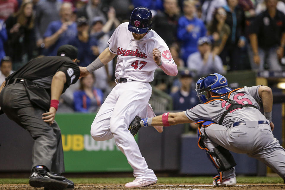 <p>Milwaukee Brewers’ Jett Bandy just beats the tag of New York Mets’ Kevin Plawecki to score during the fifth inning of a baseball game, May 13, 2017, in Milwaukee. (Photo: Tom Lynn/AP) </p>