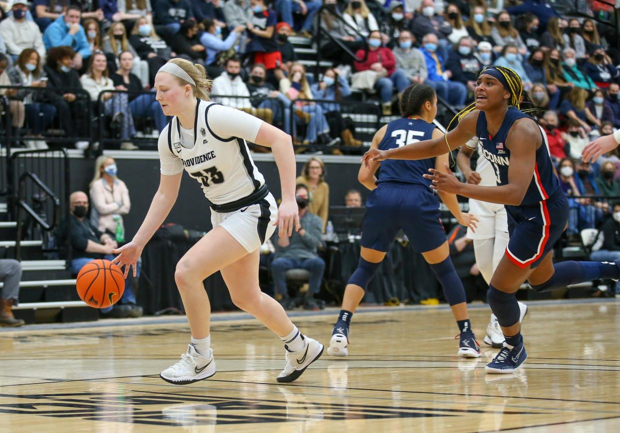 Providence College junior Emily Archibald, left, pushes the ball last season during a Big East game against Connecticut.