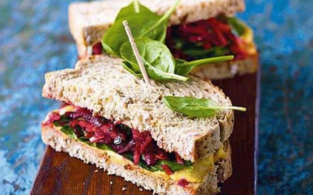 Hummus sandwich with cumin-scented carrot and beetroot salad and spinach