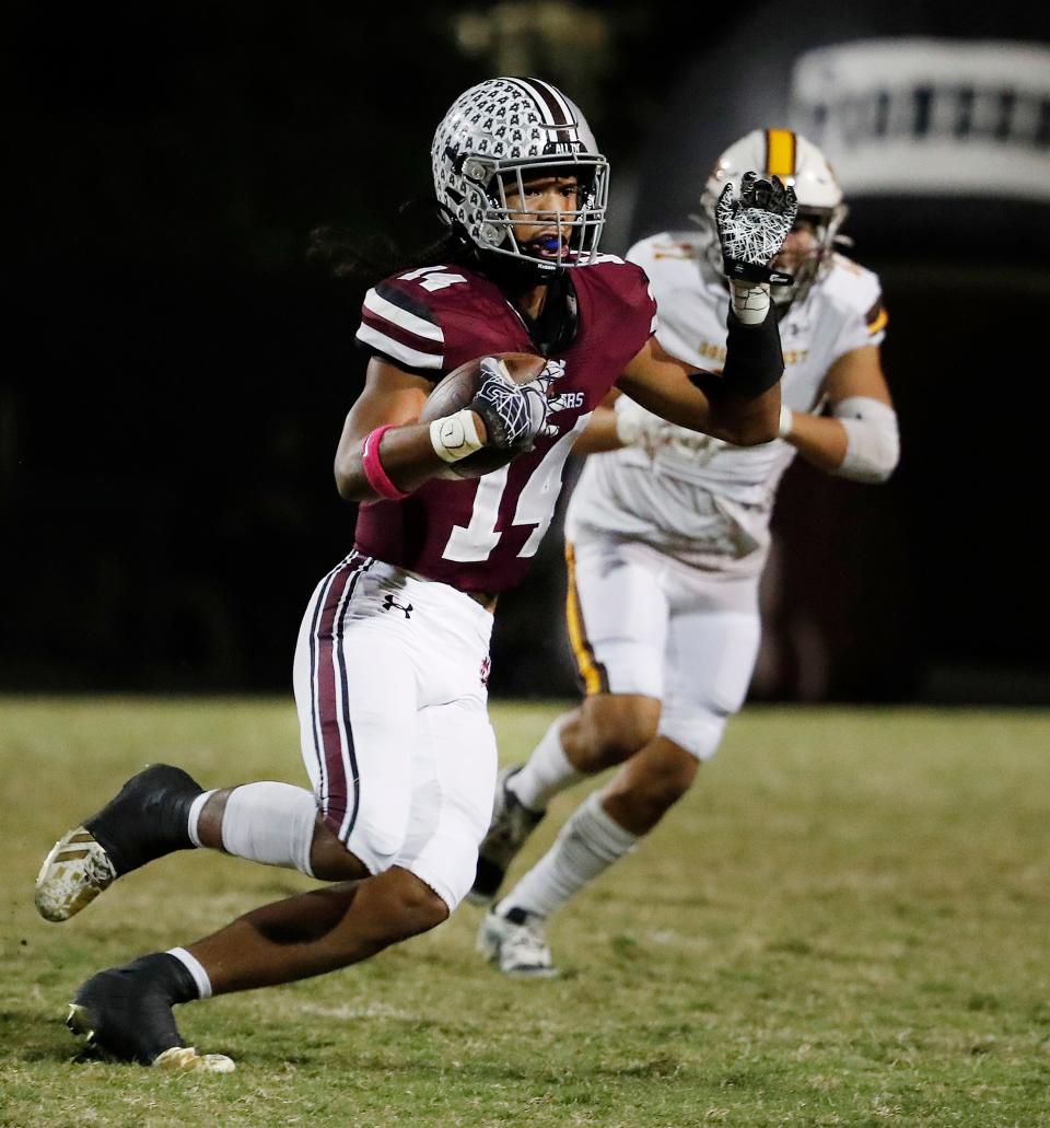 Mt. Whitney's Israel Briggs on a run against Golden West during their high school football game at Mineral King Bowl in Visalia, Calif., Friday, Oct. 6, 2023.