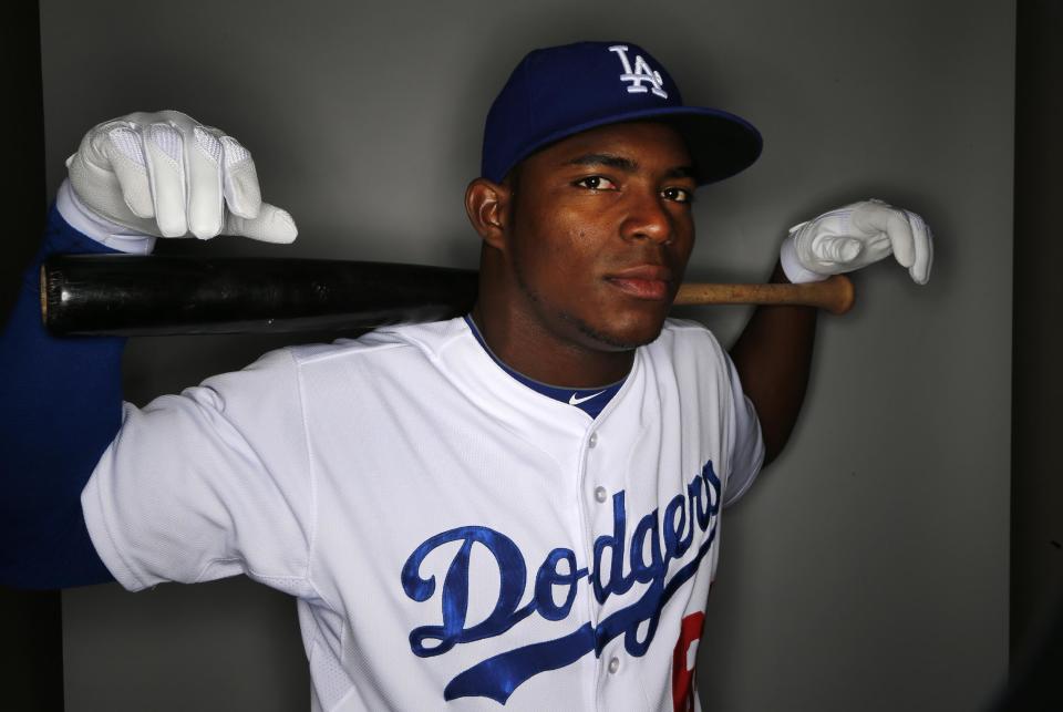 FILE - In this Feb. 20, 2014 file photo, Los Angeles Dodgers' Yasiel Puig poses for a photo during photo day for the baseball team in Glendale, Ariz. Puig fled Cuba on a boat run by smugglers who allegedly made death threats against him and a boxer, according to court documents. The papers describe a dangerous odyssey of shady characters, unpaid debts and violence. (AP Photo/Paul Sancya, File)