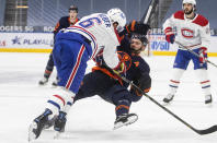 Edmonton Oilers' Leon Draisaitl (29) is checked by Montreal Canadiens' Shea Weber (6) during the second period of an NHL hockey game, Wednesday, April 21, 2021 in Edmonton, Alberta. (Jason Franson/The Canadian Press via AP)