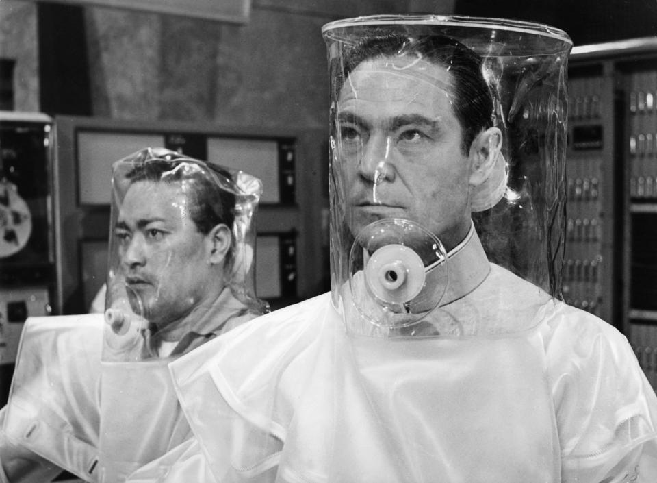 Anthony Chinn and Joseph Wiseman wearing decontamination suits in a scene from the film 'Doctor No', 1962. (Photo by United Artists/Getty Images)