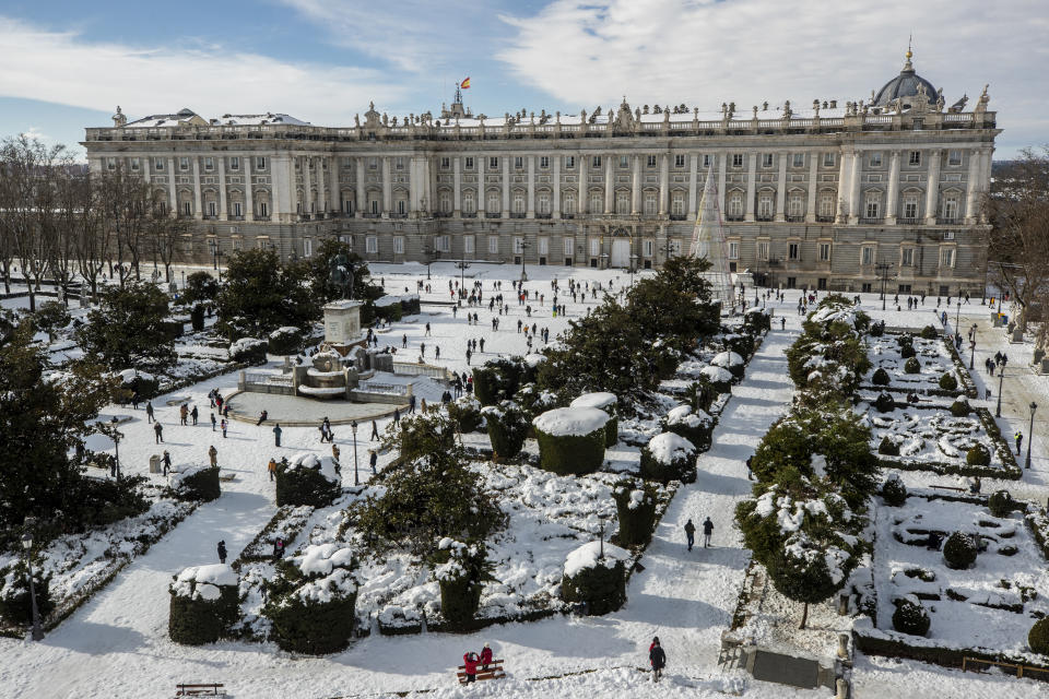 A view of Oriente square covered with snow with the Royal Palace in front in downtown Madrid, Spain, Sunday, Jan. 10, 2021. A large part of central Spain including the capital of Madrid are slowly clearing snow after the country's worst snowstorm in recent memory. (AP Photo/Manu Fernandez)