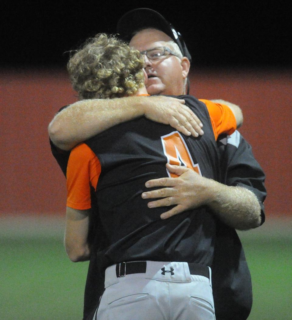 Ira coach Toby Goodwin hugs pitcher Karson Valentine (4) following a Region I-1A semifinal against Gail Borden County at Hermleigh Cardinal Field on May 17, 2019.