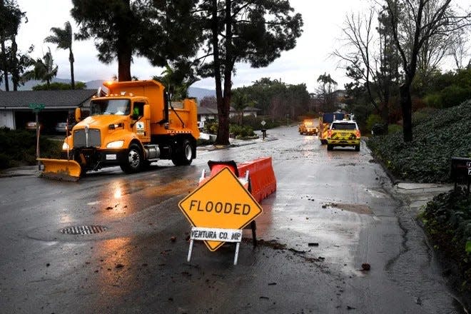 Workers with Ventura County Public Works clear debris in Camarillo, California, as rain fell across the region on Thursday, Feb. 1, 2024.