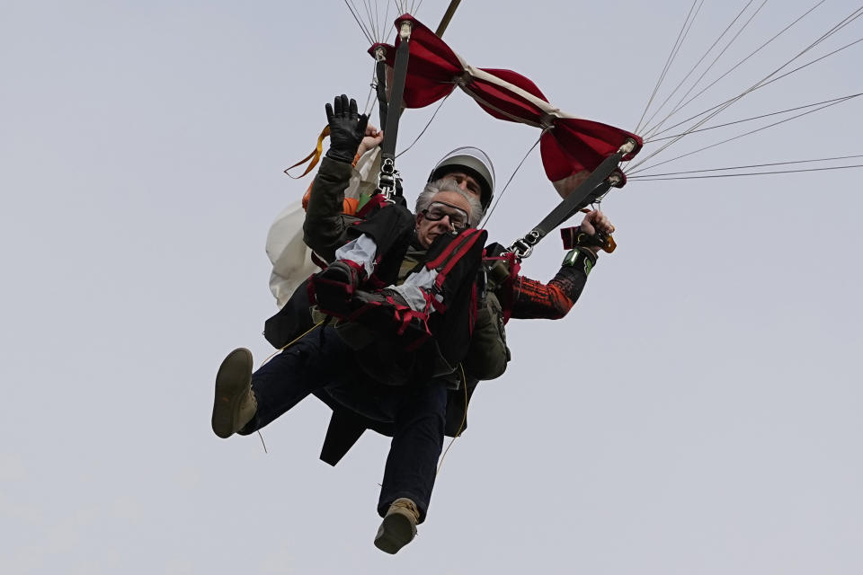 Texas Gov. Greg Abbott skydives in tandem Monday, Nov. 27, 2023, in Fentress, Texas. Abbott was invited to jump by 106-year-old World War II veteran Al Blaschke. (AP Photo/Eric Gay)