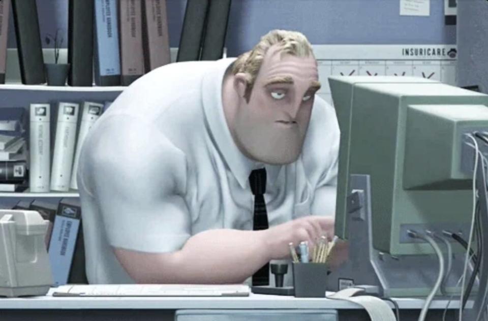 Bob Parr, also known as Mr. Incredible from the movie The Incredibles, sits at an office desk looking despondent while staring at his computer screen