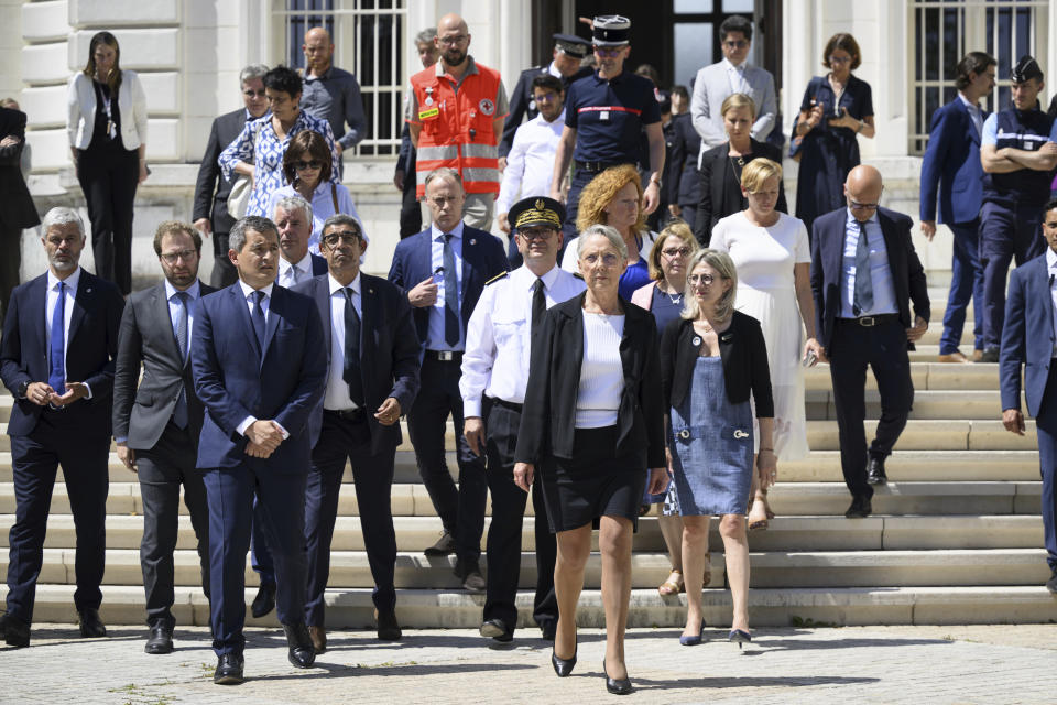 French Prime Minister Elisabeth Borne, front right, and French Interior and Overseas Minister Gerald Darmanin, front left, leave the Haute Savoie prefecture in Annecy, French Alps, Thursday, June 8, 2023. An attacker with a knife stabbed several young children and at least one adult, leaving some with life-threatening injuries, in a town in the Alps on Thursday before he was arrested, authorities said. (Jean-Christophe Bott/Keystone via AP)