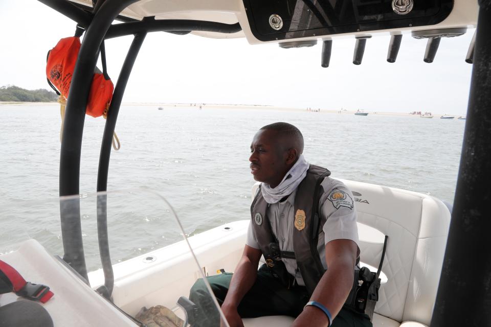 Game Warden Quintin Reed patrols along the BUll River.