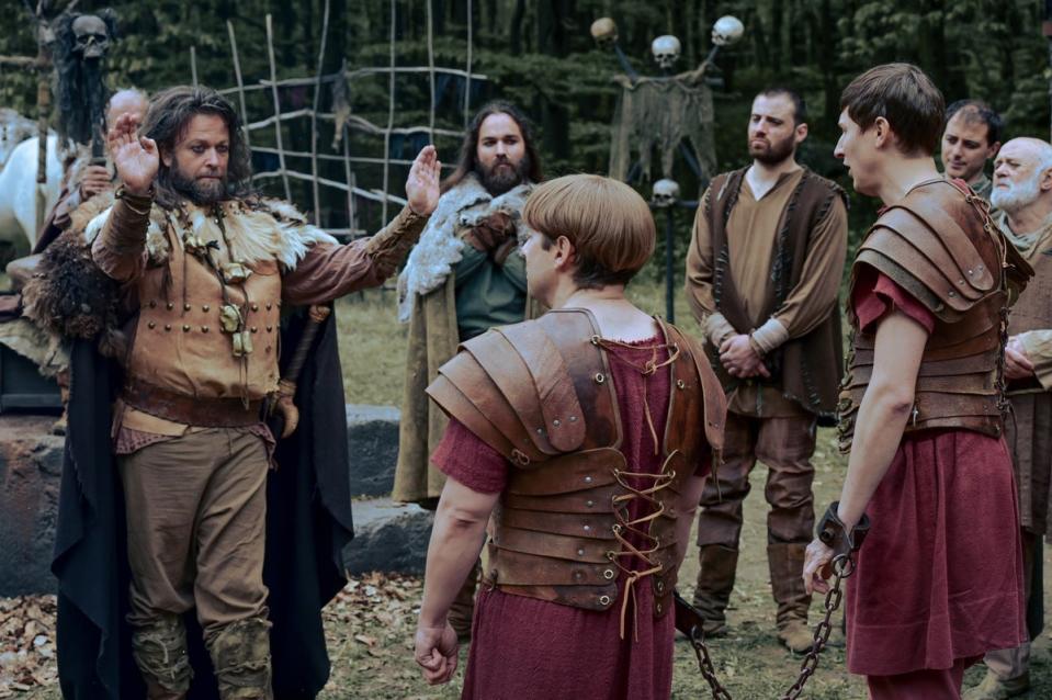 Segimundus (Kare Conradi), the leader of the ‘barbarians’, questions Grumio (Ryan Sampson) and Marcus (Tom Rosenthal) (Rise Films)