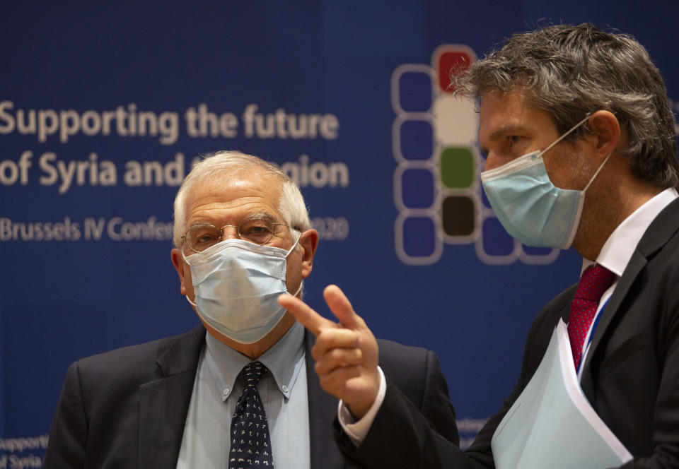 European Union foreign policy chief Josep Borrell, left, waits for the start of a meeting, Supporting the future of Syria and the Region, in videoconference format at the European Council building in Brussels, Tuesday, June 30, 2020. (AP Photo/Virginia Mayo, Pool)