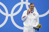 Caeleb Dressel, of the United States, poses with the gold medal after winning the men's 100-meter freestyle final at the 2020 Summer Olympics, Thursday, July 29, 2021, in Tokyo, Japan. (AP Photo/Charlie Riedel)