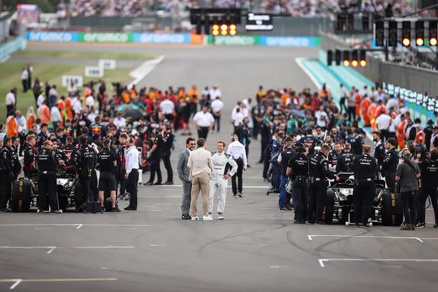 <p>Ryan Pierse/Getty Images</p> Brad Pitt and Javier Bardem on the grid at the F1 Grand Prix of Great Britain at Silverstone Circuit in July 2023