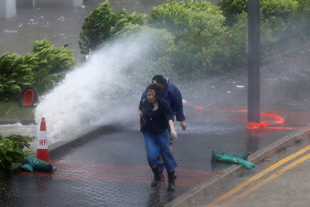 People react as Typhoon Hato hitting in Hong Kong, China August 23, 2017. REUTERS/Tyrone Siu