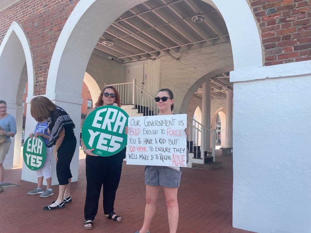 A sign reading, "Our government is bold enough to force you to have a kid but too weak to ensure they will make it to recess alive," was among those held by protesters of the U.S. Supreme Court's ruling Friday that overturns federal abortion rights.