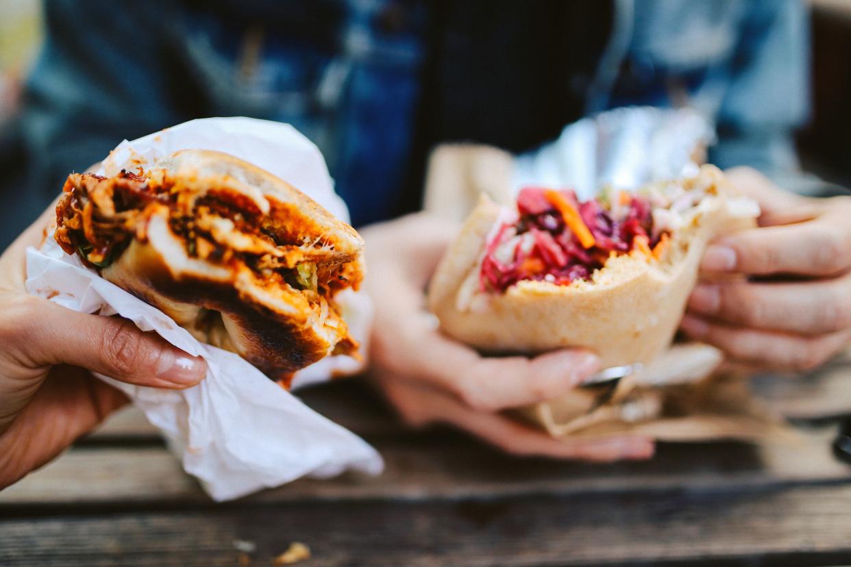 close up of a Texas pulled pork bbq burger and a falafel outdoors