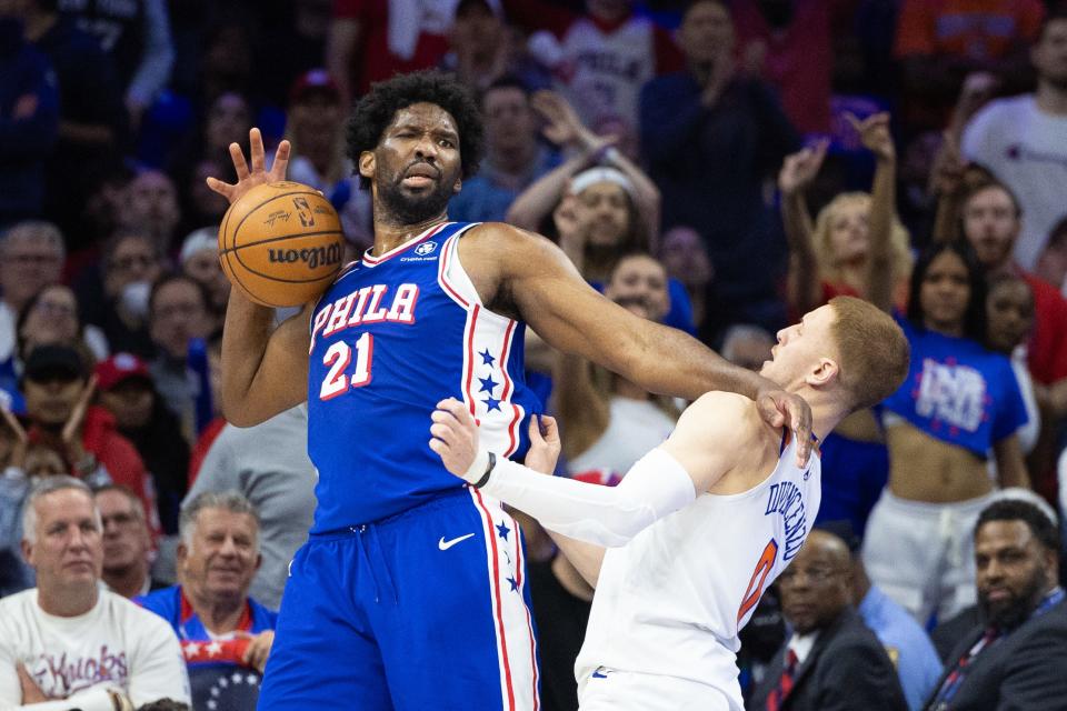 Philadelphia 76ers center Joel Embiid (21) is fouled by New York Knicks guard Donte DiVincenzo (0) during the second half of Game 3 of the first round of the 2024 NBA playoffs at Wells Fargo Center.