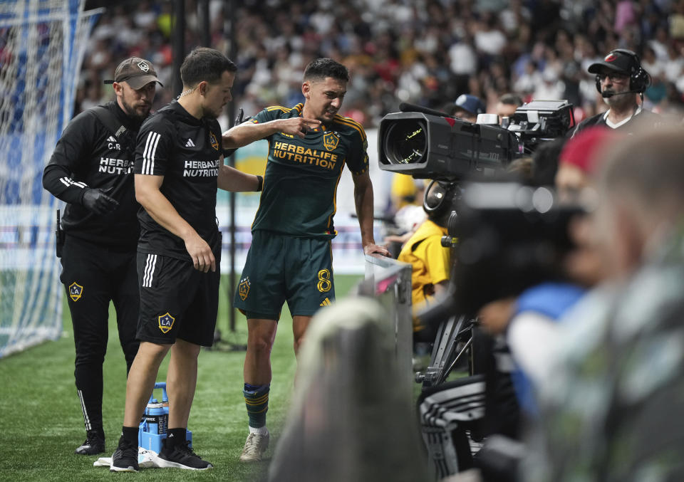 Los Angeles Galaxy's Mark Delgado (8) leaves the field after being injured during the second half of the team's MLS soccer match against the Vancouver Whitecaps on Saturday, July 15, 2023, in Vancouver, British Columbia. (Darryl Dyck/The Canadian Press via AP)