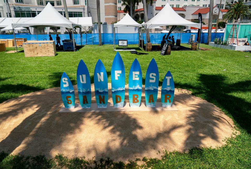 People put together their booths for Sunfest in West Palm Beach, Florida on May 4, 2023. 