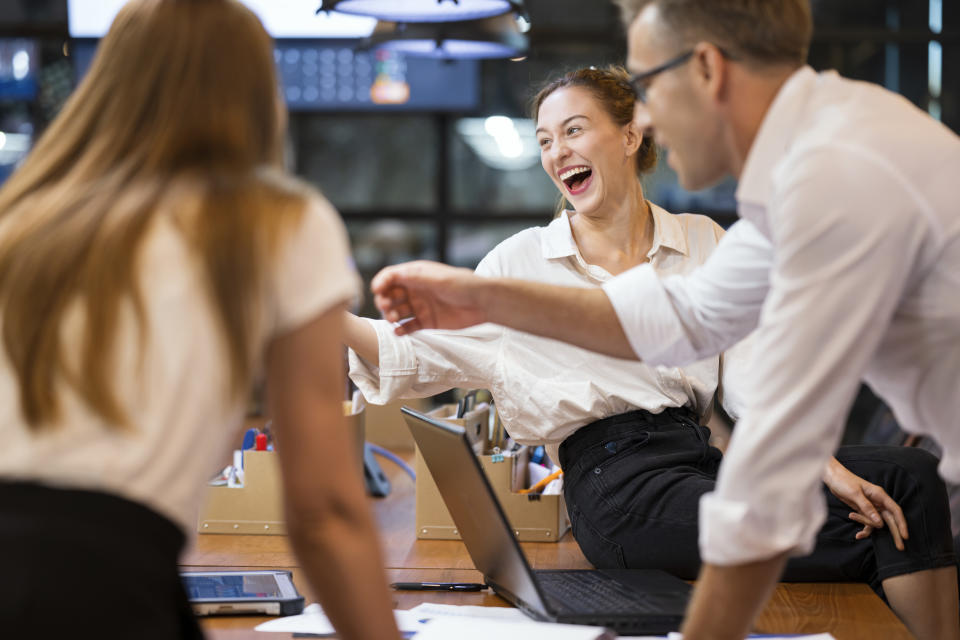 Make Meetings Fun and Engaging in Tech Team Development. Laughing Business Development Team during a project meeting in a tech business office. They are enjoy working as a team and motivation.