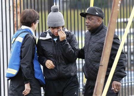 A student is reunited with a family member outside the Rosemary Anderson High School in Portland, Oregon December 12, 2014. REUTERS/Steve Dipaola