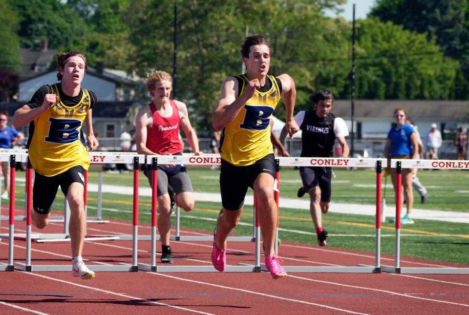 Barrington's Ethan Knight (right) sprints the final meters to the finish line ahead of teammate Bobby Wind to finish first and second in the 110 hurdles and help the Eagles win the boys team state championship title on Saturday afternoon.