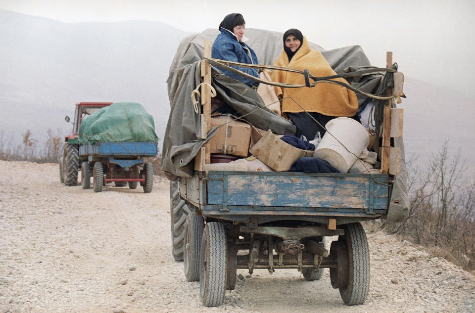 FILE - Refugees from Bosnia-Herzegovina flee their hometown of Livno on tractors over the mountain pass near Vaganj, Tuesday, April 14, 1992, after the Yugoslav federal army attacked the region. Survivors of war crimes committed during Bosnia’s 1992-95 war say the victims of ongoing human rights abuses in Ukraine should learn from their experience of fighting for justice, but that they must first make peace with the fact that reaching it will inevitably be a lengthy and painful process. (AP Photo/Michel Euler, File)