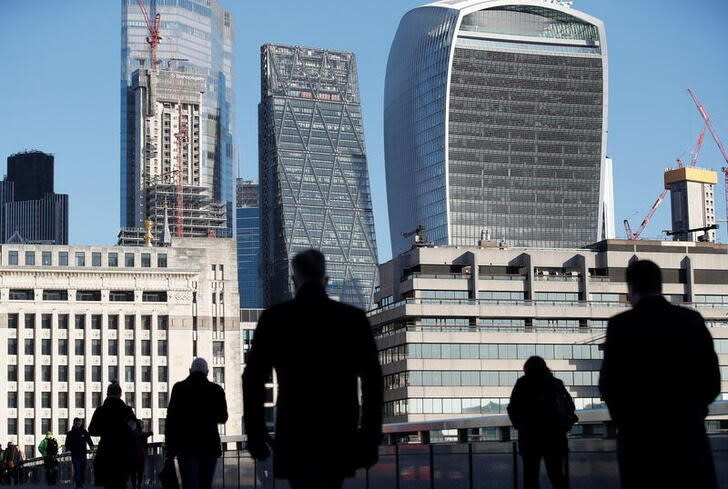 Commuters walk across London Bridge amid the spread of the COVID-19, in London