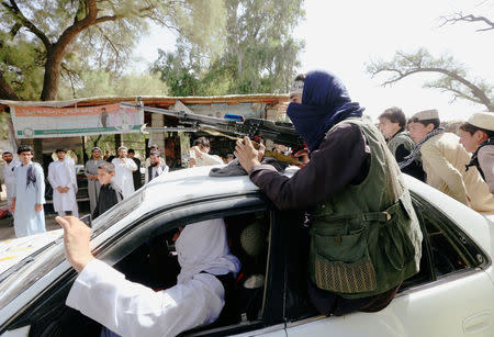 People gathered Taliban as they celebrate ceasefire in Bati Kot district of Nangarhar province, Afghanistan June 16, 2018.REUTERS/Parwiz