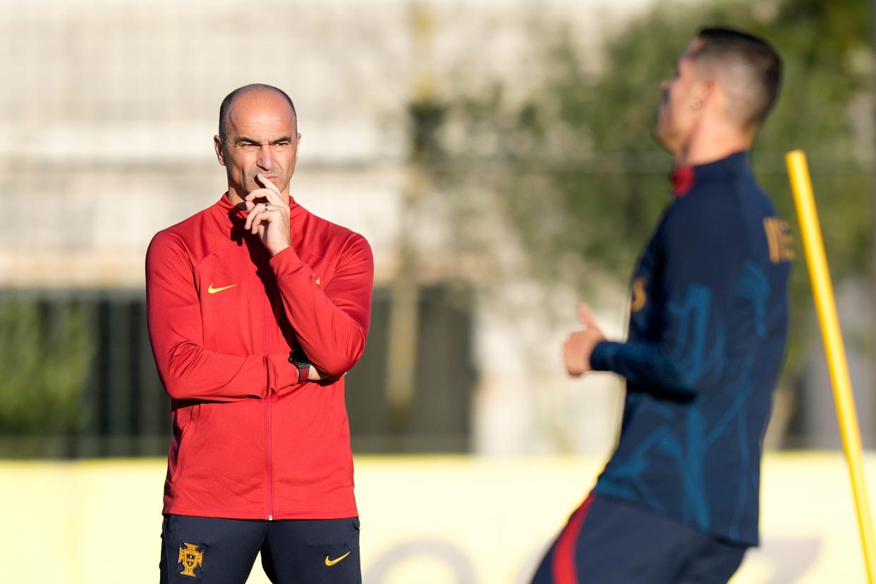 Portugal coach Roberto Martinez watches Cristiano Ronaldo, right, during a Portugal soccer team training session in Oeiras, outside Lisbon, Tuesday, March 21, 2023.