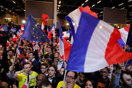 Supporters of Emmanuel Macron, head of the political movement En Marche !, or Onwards !, and candidate for the 2017 French presidential election, celebrate after partial results in the first round of 2017 French presidential election, at the Parc des Expositions hall in Paris, France April 23, 2017. REUTERS/Philippe Wojazer