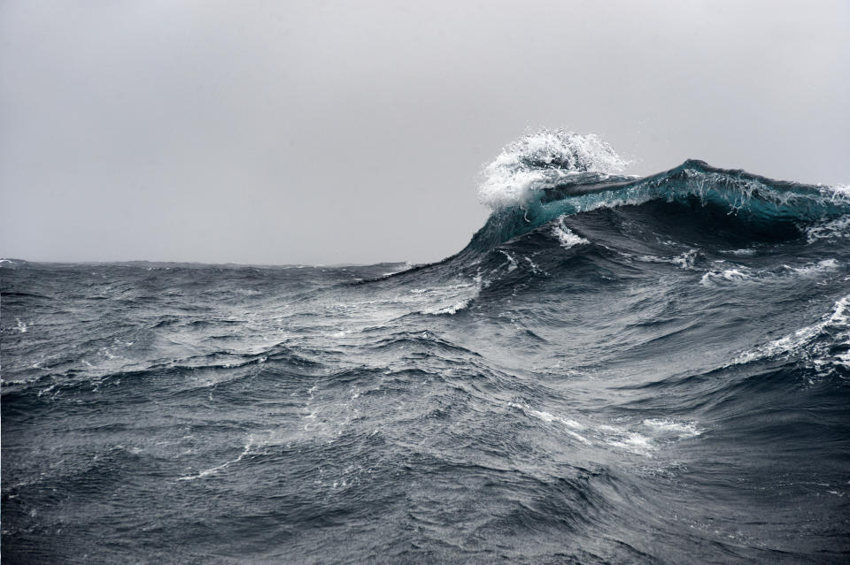 Breaking wave on a rough sea against overcast sky, Southern Ocean.