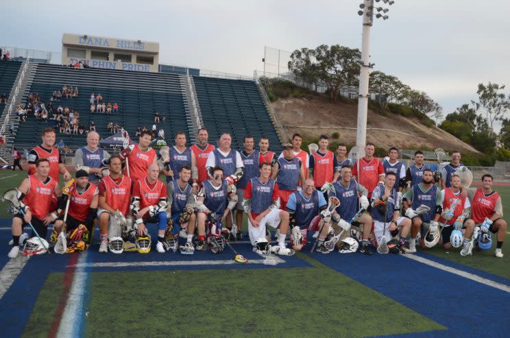 A key part of Shootout for Soldiers is the forum it gives for veterans and current service members to connect. Those who played in the veteran's game posed for a picture together. (Jackie Bamberger/Yahoo Sports)