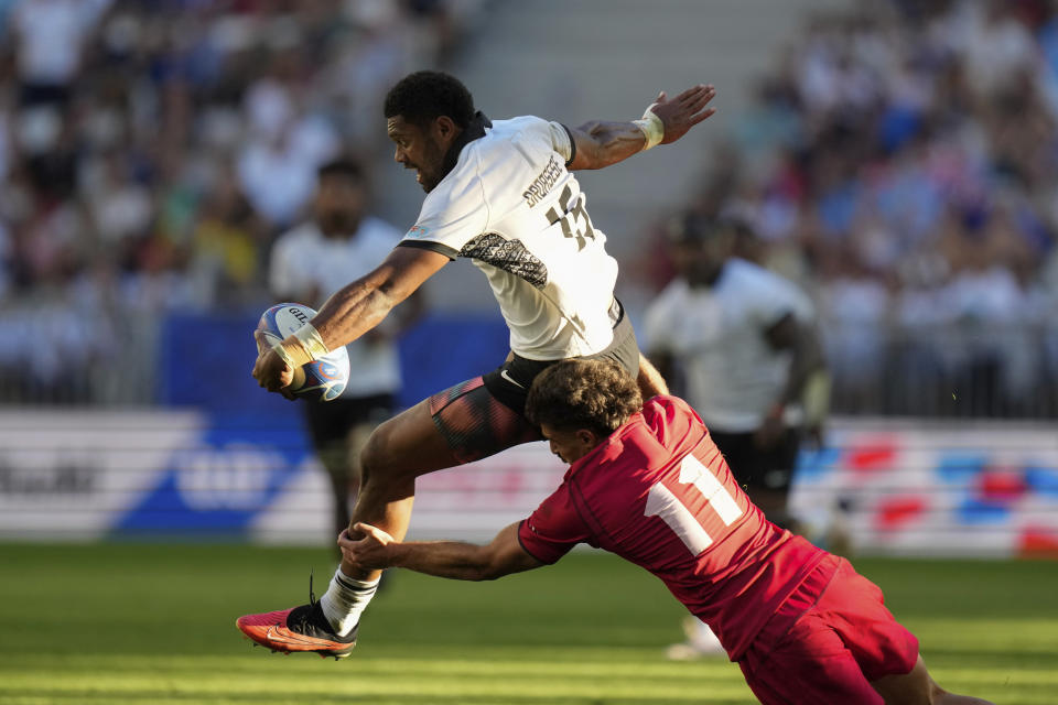 Fiji's Ilaisa Droasese is tackled by Georgia's Davit Niniashvili during the Rugby World Cup Pool C match between Fiji and Georgia at the Stade de Bordeaux in Bordeaux, France, Saturday, Sept. 30, 2023. (AP Photo/Thibault Camus)