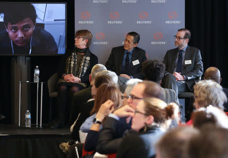 Reuters' President and Editor-in-Chief Stephen Adler, Executive Editor of Editorial operations Reg Chua (C) and Committee to Protect Journalists' chair Kathleen Carroll watch a video about the detention of detained Reuters journalists Wa Lone and Kyaw Soe Oo in Myanmar, during a panel discussion in Toronto, Ontario, Canada February 12, 2018. REUTERS/Chris Helgren