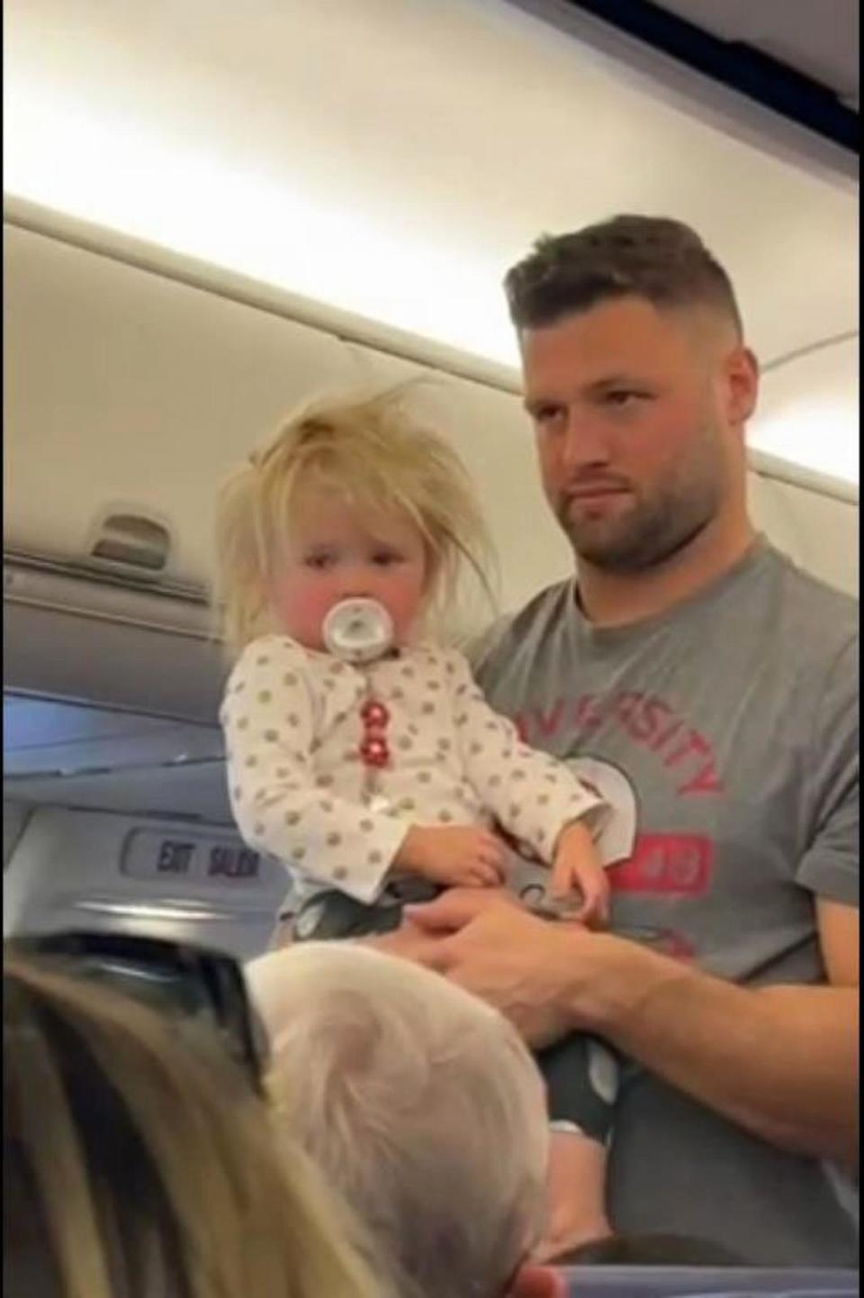 PHOTO: Vince Biegel holds his daughter Meadow on a flight from Kansas to Florida in October 2023. (Sarah Biegel  )