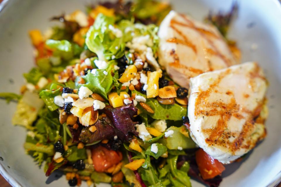 Grilled chicken and mango salad at Tommy Bahama Restaurant & Bar is a top 5 menu mainstay since opening decades ago.