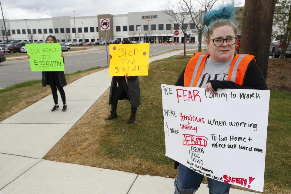 <span class="caption">Amazon employees hold signs outside a fulfillment center in Romulus, Michigan.</span> <span class="attribution"><span class="source">AP Photo/Paul Sancya</span></span>