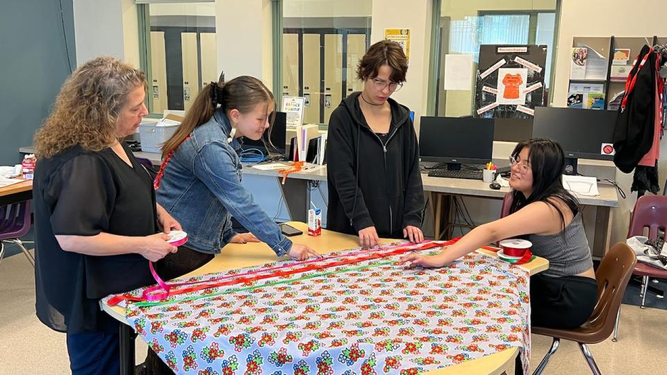 Harris, second from the left, has been giving back at Argyle before she leaves by teaching other students how to sew ribbon skirts.