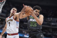 Minnesota Timberwolves center Karl-Anthony Towns, right, pulls in a rebound next to Denver Nuggets forward Michael Porter Jr. during the second half of Game 5 of an NBA basketball first-round playoff series Tuesday, April 25, 2023, in Denver. (AP Photo/David Zalubowski)