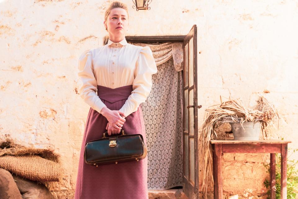 Amber Heard plays a doctor who visits a remote village to care for a boy who may or may not be possessed in the 1890s-set period chiller "In the Fire."