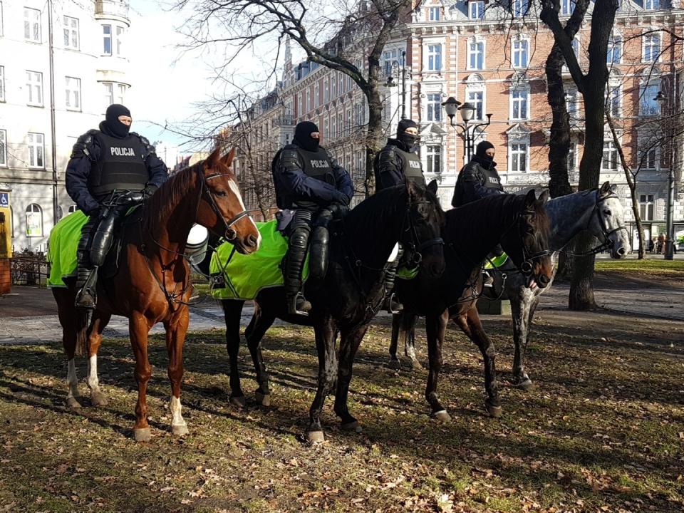 Polish police on horseback watch as environmental activists gather in Katowice, Poland, for the start of a march demanding action to curb climate on Saturday, Dec. 8, 2018. (AP Photo/Frank Jordans)