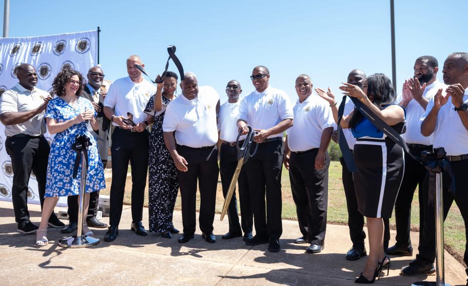 People celebrate  the ribbon cutting Friday at the grand opening of the Garden Oaks Community Center. The Alpha Community Foundation of Oklahoma purchased the former Garden Oaks Elementary School several years ago and has transformed it into a community center.