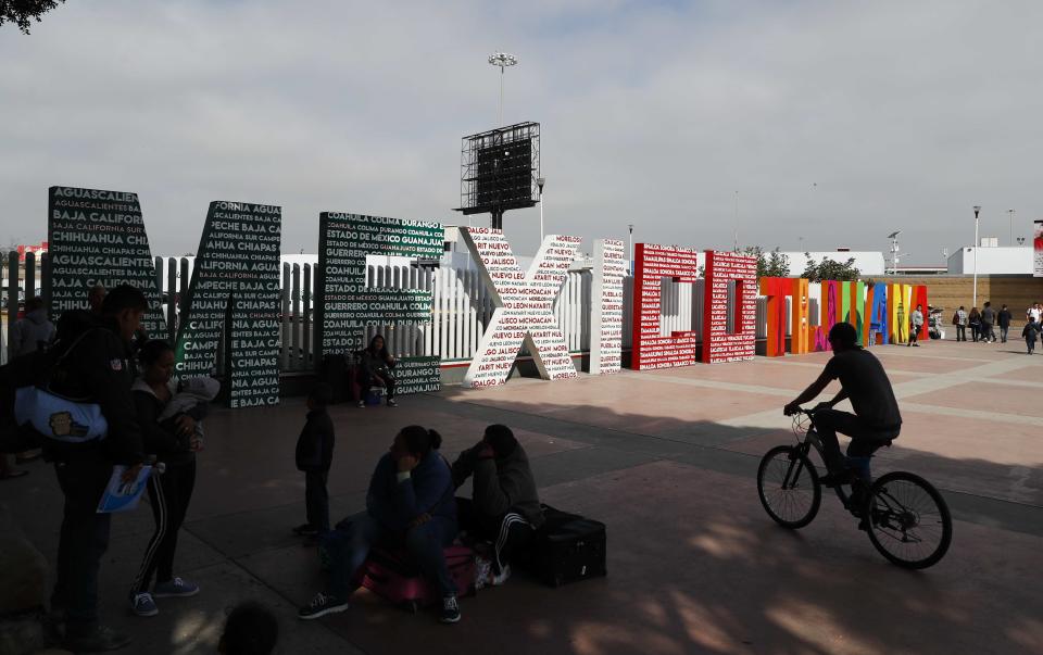 The words "Tijuana, Mexico" stand on the Mexican side of the border with the U.S. where migrants wait to be attended to apply for asylum in the U.S., in Tijuana, Mexico, Sunday, June 9, 2019. The mechanism that allows the U.S. to send migrants seeking asylum back to Mexico to await resolution of their process has been running in Tijuana since January. (AP Photo/Eduardo Verdugo)