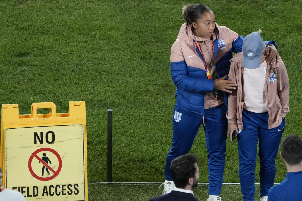 England's Lauren James, third right, leans on a teammate as they walk off the field during a team ground familiarization ahead of their Women's World Cup quarterfinal soccer match at Stadium Australia in Sydney, Australia, Friday, Aug. 11, 2023. England is scheduled to play Colombia Saturday. (AP Photo/Rick Rycroft)